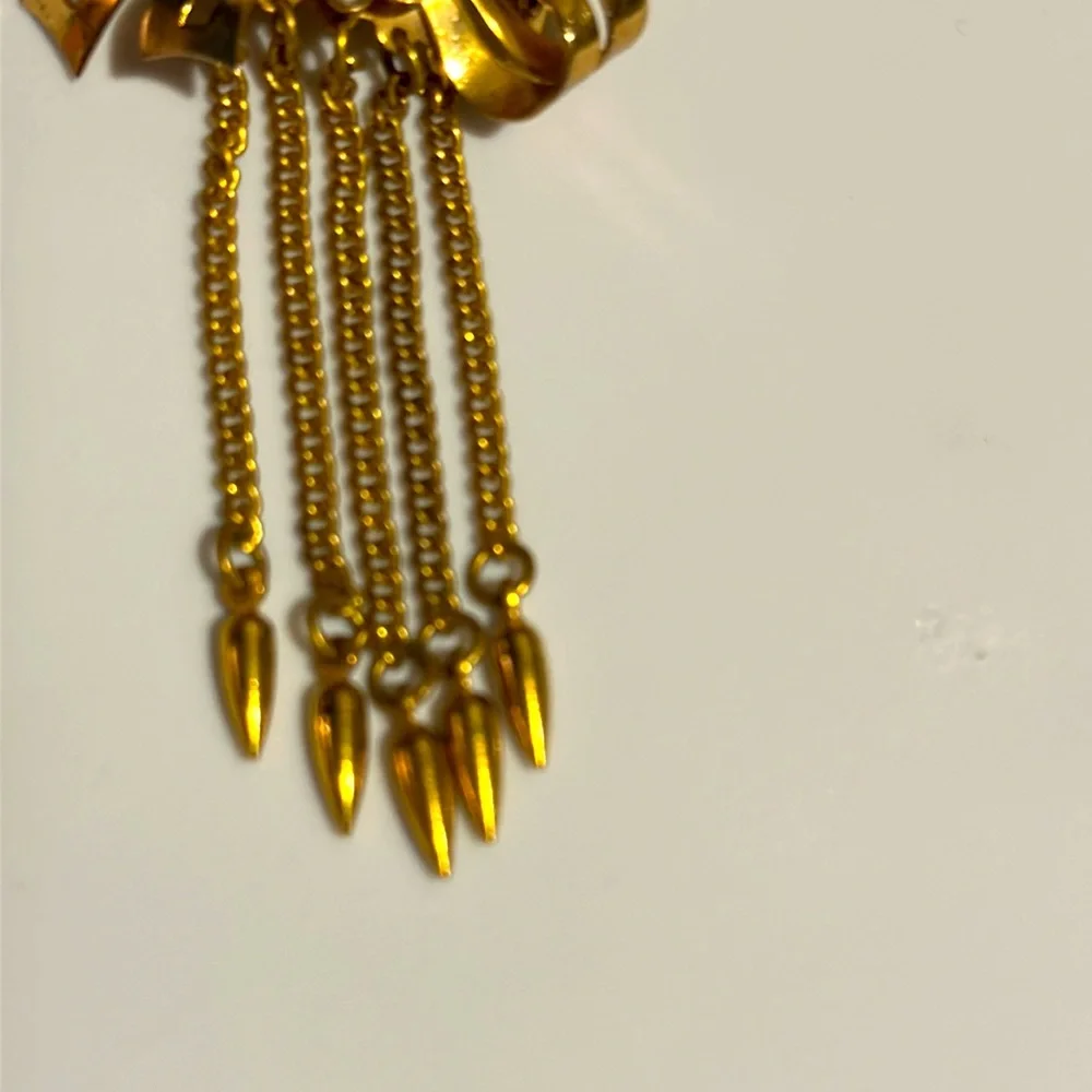 Vintage Coro gold tone bow with rhinestone center and hanging chains (679)